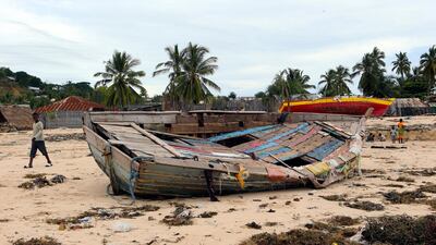 A young boy walks past a fishing boat that was destroyed when Cyclone Kenneth struck in Pemba city on the northeastern coast of Mozambique. Cyclone Kenneth arrived late Thursday, just six weeks after Cyclone Idai ripped into central Mozambique and killed more than 600 people. AP