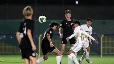 Pumas Unam (in white) and Manchester City Football Schools (black) in action.