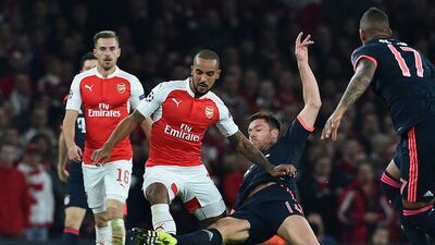Theo Walcott avoids a challenge from Bayern Munich's Xabi Alonso in Arsenal's Champions League win on Tuesday night at the Emirates Stadium. Ben Stansall / AFP / October 20, 2015