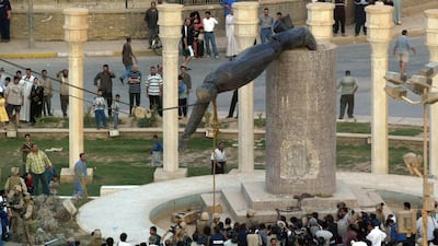 Iraqis watch a statue of Saddam Hussein being toppled in Al Firdous Square in Baghdad. Patrick Baz/ AFP