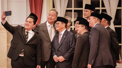 New Indonesian government ministers take a group photo before their swearing-in ceremony at the Presidential Palace in Jakarta. AFP