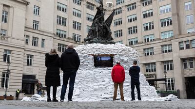 Liverpool residents look at 'Protect the Beats', a public installation made in solidarity with Ukrainians, at Exchange Flags. EPA
