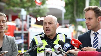 Police talk to the members of the media. Getty Images