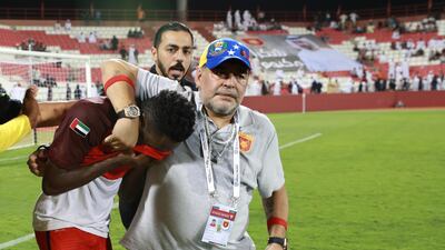 Fujairah coach Diego Maradona comforts one of his distraught players after they missed out on automatic promotion to the Arabian Gulf League. Victor Besa / The National
