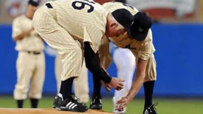 Former New York Yankees White Ford, left, and Don Larsen collect dirt on the mound before the final regular season MLB American League baseball game at Yankee Stadium in New York, September 21, 2008.