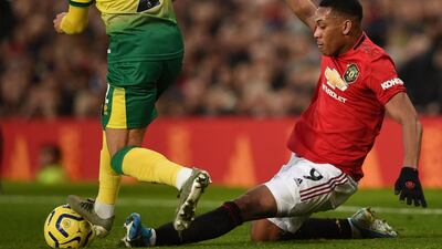 Manchester United's Anthony Martial, right, tackles Norwich City's Max Aarons. AFP