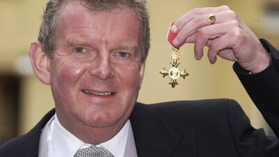 Motson receives an OBE at Buckingham Palace in 2001. PA