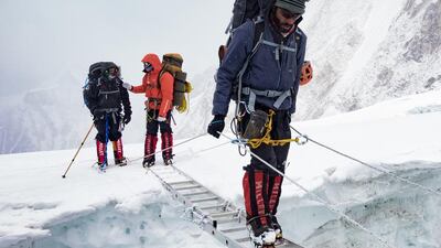 Abdul Aziz Al Tameemi crosses a crevasse while climbing Everest. Courtesy UAE Armed Forces