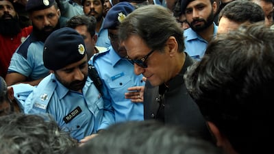 Former Pakistan prime minister Imran Khan arrives at Islamabad High Court surrounded by security in Islamabad last month. AP