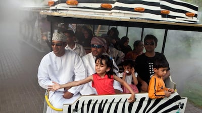 Aren Alok, 6, cools herself on the Al Ain Zoo visitors’ train as it passes a mist stream.