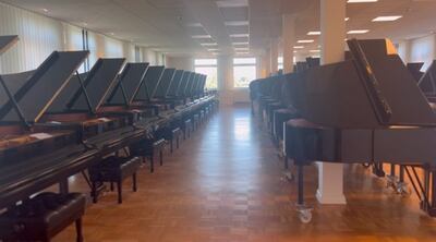 Newly finished Steinway grand pianos in the selection room, where clients test and choose instruments before they are shipped. Saeed Saeed / The National