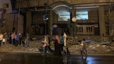 People look on at the damage left by a fire from a blast outside the National Cancer Institute, Cairo, Egypt. EPA