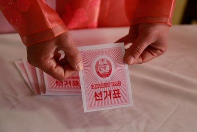 An electoral worker shows a ballot during the election at a polling station in Pyongyang. AP