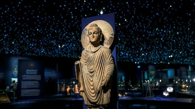 A third-century Buddha sculpture from Gandhara, in present-day Pakistan, on display at Louvre Abu Dhabi's Spices and Wonders exhibition. Victor Besa / The National