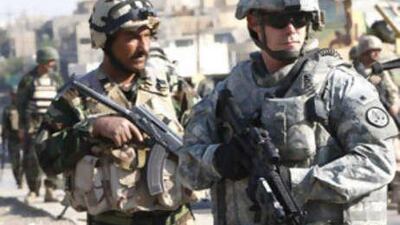 Iraqi and US soldiers gauge the area following a roadside bomb in the northern city of Mosul, about 370 kilometres from Baghdad.