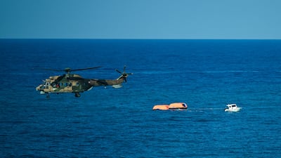 A Turkish helicopter searches the waters during a rescue operation. AFP