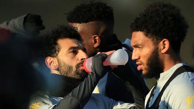 Mohamed Salah takes a drinks break as Joe Gomez looks on. AFP