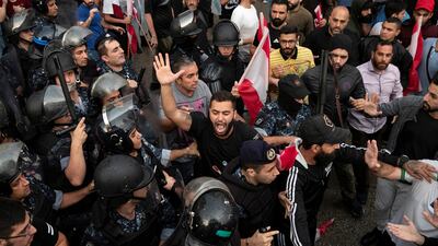 A demonstrator reacts as riot police interfere to stop demonstrators scuffling with each other in Beirut. Reuters