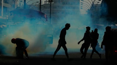 Security forces fire tear gas during clashes with protesters in Baghdad, Iraq. AP Photo