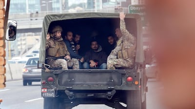 Lebanese army soldiers leave after arresting at least five people who tried to block the highway during an anti-government protest at the Jal El Dib area north of Beirut, Lebanon. EPA