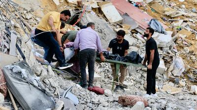 A body is carried from the site of an Israeli strike on Arab Salim, in southern Lebanon. EPA