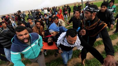A wounded Palestinian demonstrator is evacuated during clashes with Israeli troops at a protest against President Trump's decision to recognise Jerusalem as the capital of Israel, near the border with Israel in the southern Gaza Strip. REUTERS/Ibraheem Abu Mustafa