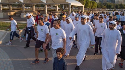 Sheikh Abdullah bin Zayed walks with staff and their families as part of a healthcare initiative aimed at encouraging employees to pursue healthy lifestyles.