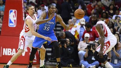 Oklahoma City Thunder player Kevin Durant, centre, loses the ball against Houston Rockets player Francisco Garcia, left, and James Harden in the first half of their NBA basketball game at the Toyota Center in Houston, Texas, USA on Friday. Larry W Smith / EPA / April 4, 2014