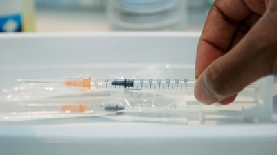 A medical worker with a syringe containing a dose of the Pfizer-BioNTech Covid-19 vaccine at a vaccination centre in Neuilly-sur-Seine, France, on February 19, 2021. Reuters