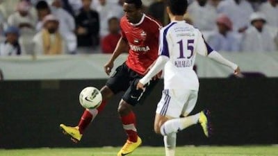 Al Ain´s Khaled Abdulrahman, white, and Al Ahli´s Ahmed Khalil fight for the ball.