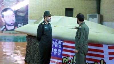 General Amir Ali Hajizadeh, left, speaks to an Iranian colonel after capturing the US RQ-170 Sentinel drone in December.