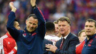 Manchester United manager Louis van Gaal, right, and assistant Ryan Giggs, left, react following the team's FA Cup final victory on Saturday. Andy Rain / EPA / May 21, 2016