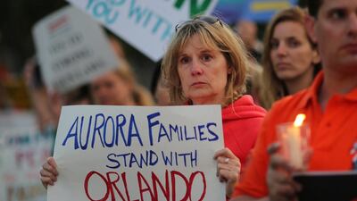 Anita Busch, who says her cousin Micayla Medek, 23, was killed in the mass shooting in Aurora, Colorado, attends a candlelight vigil in West Hollywood, California, following the early morning attacks on a nightclub. David McNew / Reuters