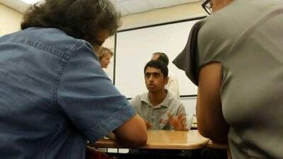 A grade 11 student talks to Swiss teachers at the Institute of Applied Technology.