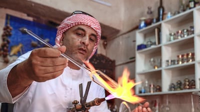 Local artisans conduct workshops in traditional metalwork, pottery, glass blowing and Arabic cloak making. Emirati craftsman Noor Ahmad is busy in his workshop in Abu Dhabi's Heritage Villlage. Victor Besa/The National
