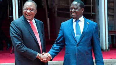 Kenya's President Uhuru Kenyatta, left, shakes hands with opposition leader Raila Odinga of the National Super Alliance coalition outside the president's office in Nairobi on March 9, 2018. Simon Maina / AFP