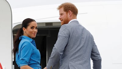 Britain's Prince Harry and Meghan, Duchess of Sussex look on before departing from Fua'amotu International Airport in Tonga. Reuters