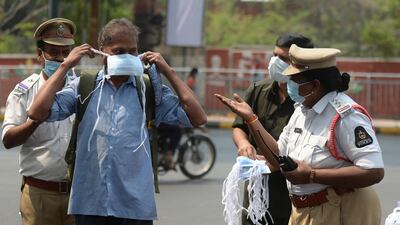 A woman police officer tells a man to wear face mask during an awareness campaign against the spread of Covid-19 at a traffic junction in Hyderabad, India, on April 7, 2021. AFP