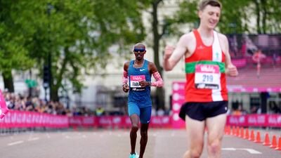 Mo Farah crosses the line to finish in second place in the men's race during the Vitality London 10,000. PA