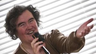 Susan Boyle poses singing with a hairbrush at her home in Blackburn, Scotland.