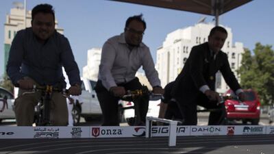 Abu Dhabi Media staff compete on stationary bicycles and power toy cars in Abu Dhabi. Silvia Razgova / The National