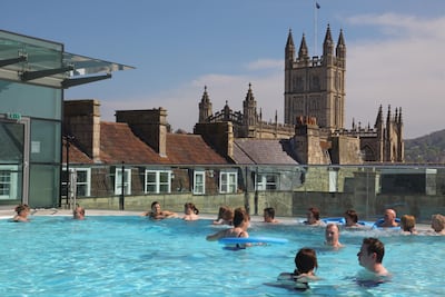 Visitors enjoy the sunshine as they swim in the rooftop pool of the Thermae Bath Spa on April 21, 2009 in Bath, England. Getty Images