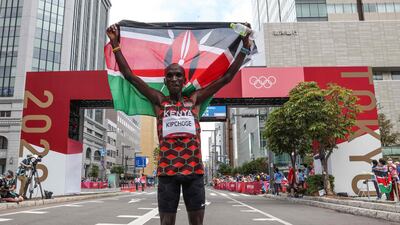 Kenya's Eliud Kipchoge celebrates after winning the men's marathon.