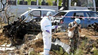 Forensic experts search for evidence in the bus wreckage at the site of explosion in the northern city of Tripoli, Lebanon, on Sept 29 2008, killing at least five people and injuring 26.