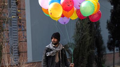 A balloon seller waits for customers at a market in Kabul. AFP
