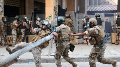 Lebanese security forces run during clashes with anti-government protesters. EPA