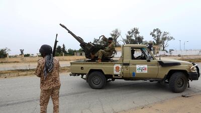 Tripoli government forces look on during clashes. AP Photo