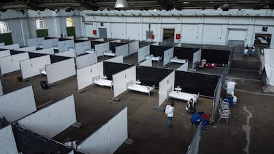 Workers install a temporary Doctors Without Borders (MSF) 50 places shelter for homeless people suspected of being infected with the novel coronavirus (COVID-19) in Brussels. AFP