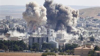 Smoke rises after a US-led airstrike on the ISIL-besieged Syrian town of Kobani on Wednesday. Murad Sezer / Reuters