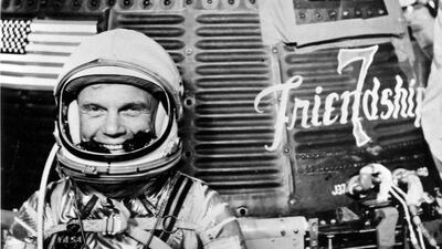 Astronaut John H. Glenn Jr, pilot of the Mercury Atlas 6 spaceflight, poses for a photo with the Mercury "Friendship 7" spacecraft during preflight activities at the Kennedy Space Center in Cape Canaveral, Florida on February 20, 1962. Courtesy NASA / handout via Reuters
